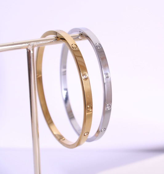 Pulseras rígidas de acero inoxidable de Hétika en dorado y plateado